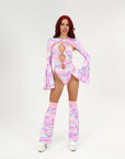 Model wearing a colorful rave outfit with a pink and purple pattern on a white background