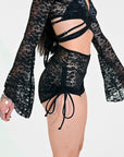 Black lace outfit with long sleeves on a white background