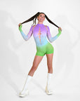 Person wearing a colorful gradient rave outfit with long sleeves and shorts on a white background.