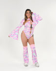 Person wearing a colorful rave outfit with a pink and purple theme on a white background