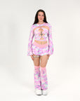 Person wearing a pink camouflage rave outfit with matching accessories on a white background