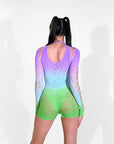 Rave Girl wearing a colorful gradient outfit with cut-out design on a white background.