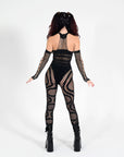 Back view of Midnight Jumpsuit black rave jumpsuit showing star detailing, snap closure behind neck, and full-length pants.