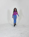 Model wearing a gradient mesh rave jumpsuit in a studio, showing full body fit, leg coverage, and how the jumpsuit moves while walking.